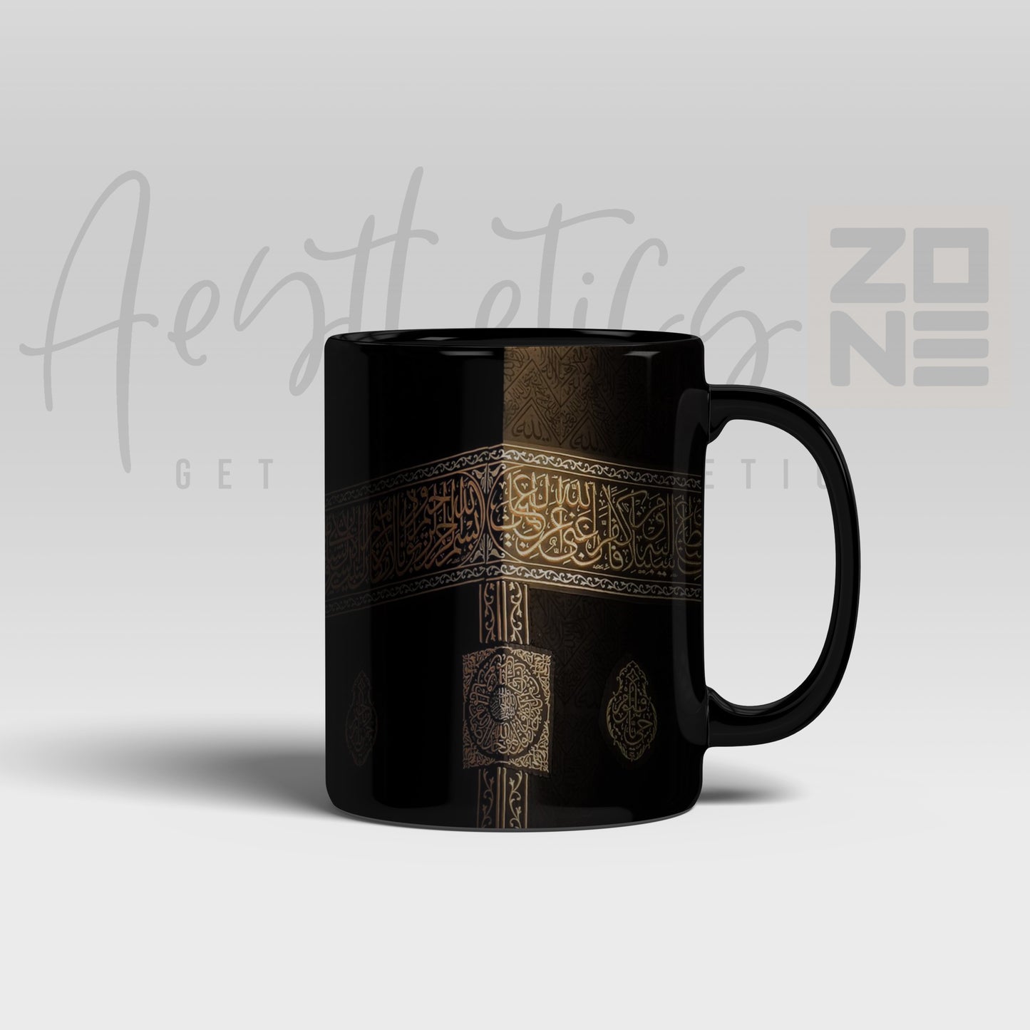 Black mug with gold design on a light gray background