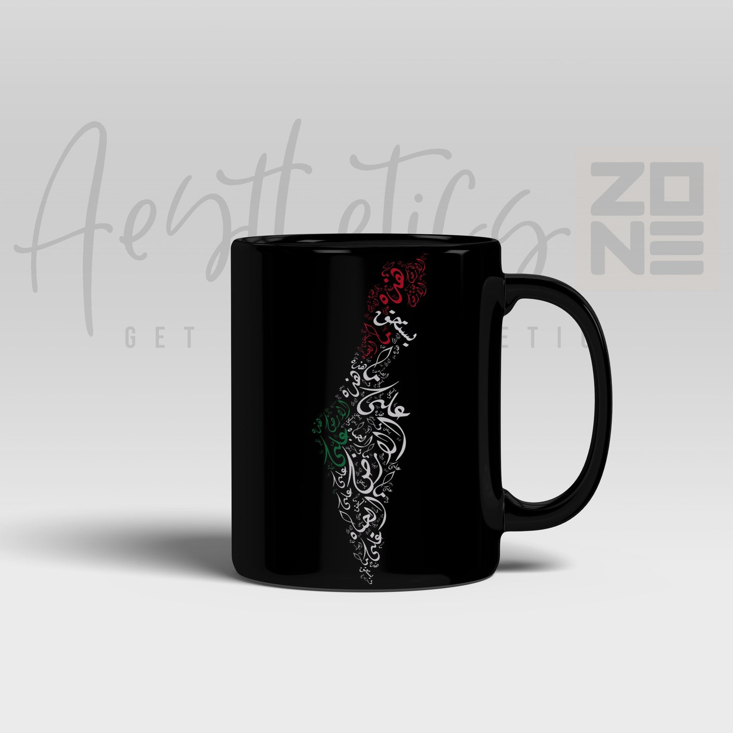 Black mug with decorative design on a light gray background