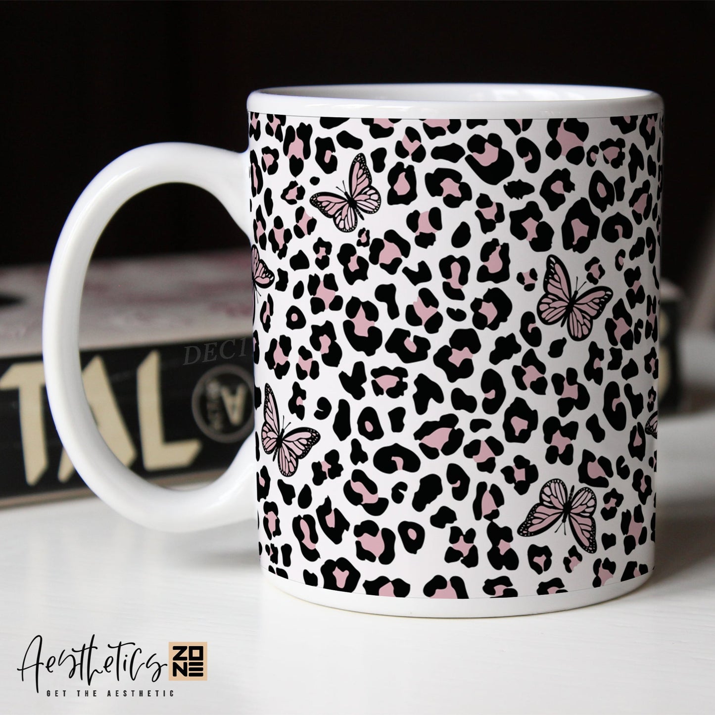 Leopard print coffee mug with butterfly designs on a white surface, with 'Aesthetic Coffee Mug' text.