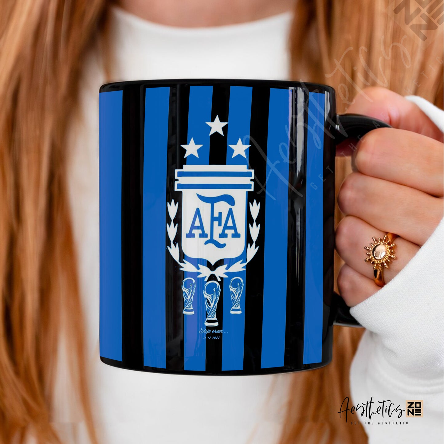 Person holding a black mug with blue stripes and AFA logo