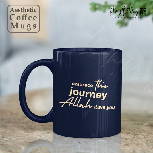 Navy blue mug with 'embrace the journey Allah gave you' text on a blurred background
