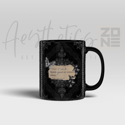 Black mug with decorative design and text on a light gray background