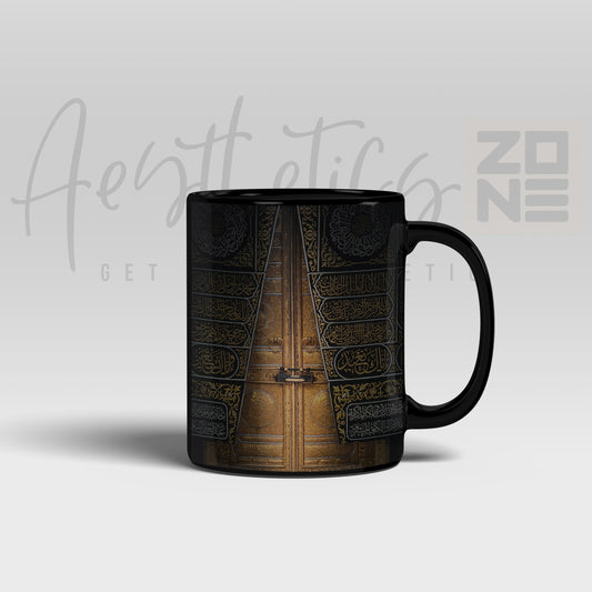 Black mug with a detailed design on a light gray background