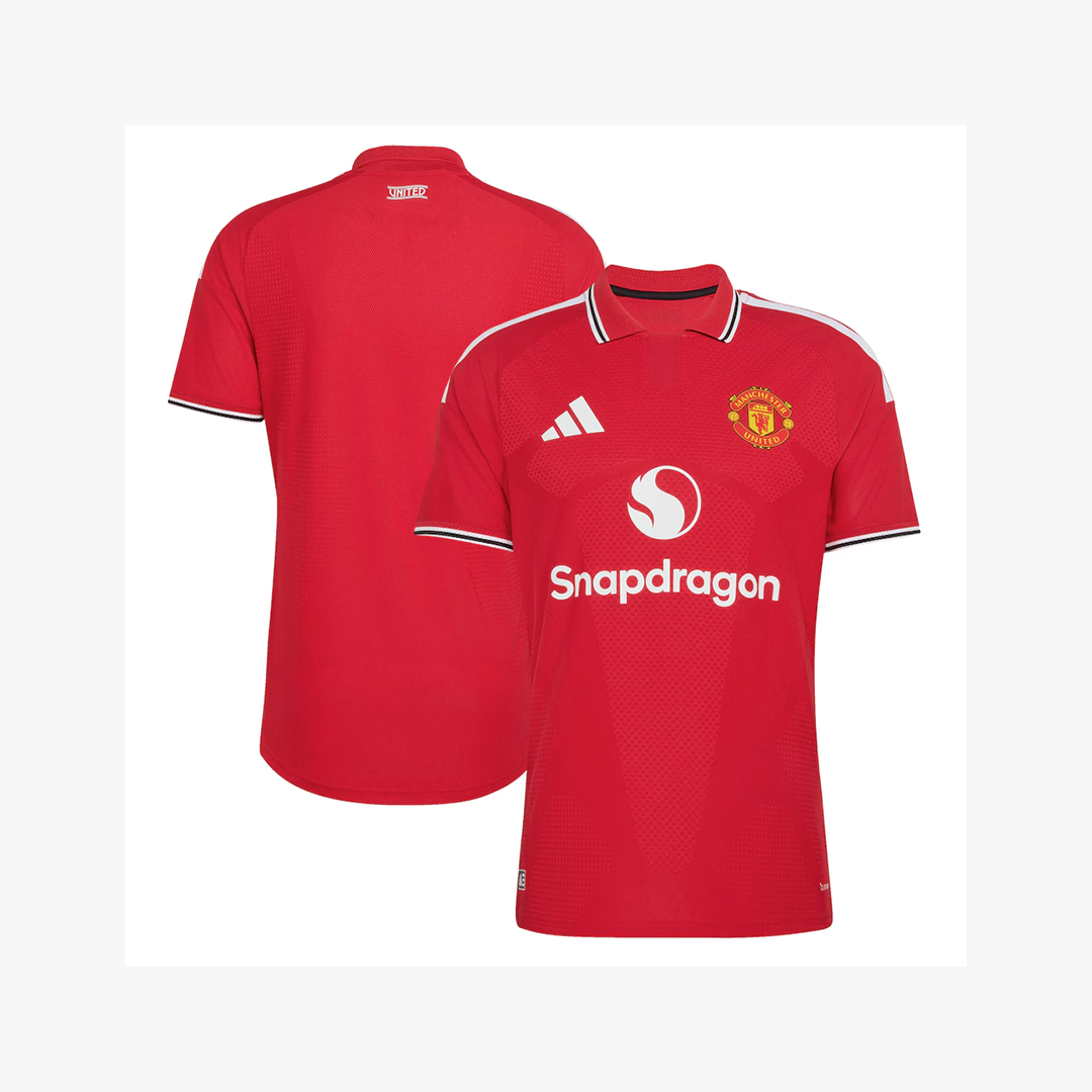 Red Manchester United short-sleeve soccer jersey shown from both front and back views on a light gray background. The front features the Manchester United crest, white Adidas logo, and white Snapdragon sponsor logo, with white and navy striped trim on the collar and sleeves.