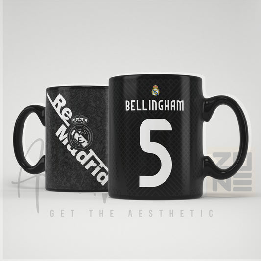 Black coffee mug with 'Real Madrid' and number '5' design on a white background