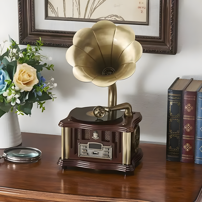 Vintage-style gramophone on a wooden surface with books and flowers in the background