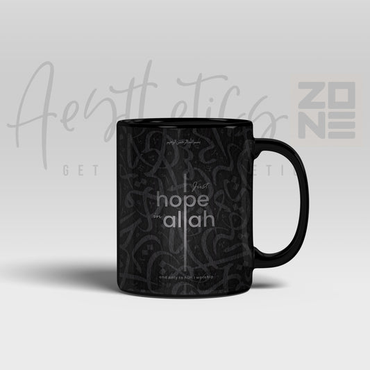 Black mug with 'I just hope for Allah' text on a light gray background