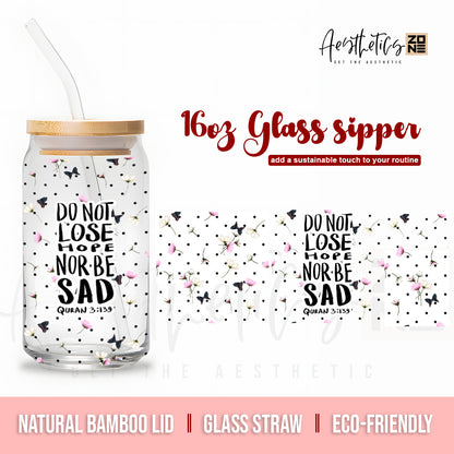 Glass sipper with motivational quote and bamboo lid on a white background