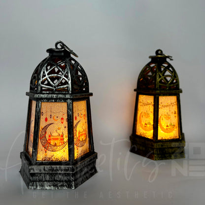 Two ornate lanterns with intricate designs on a gray background