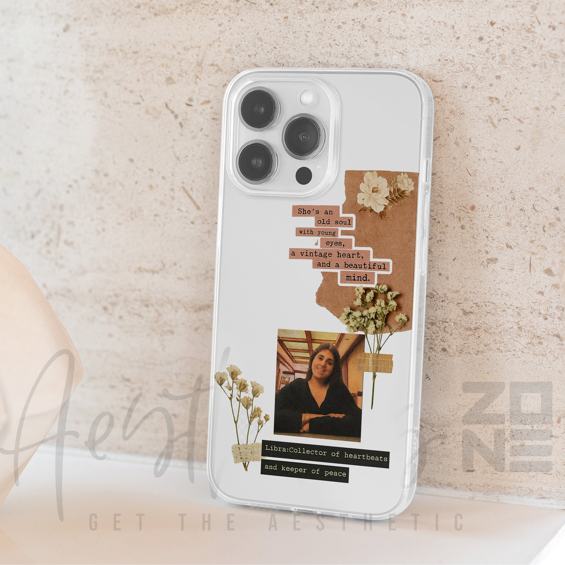 Phone case with floral design and text on a beige background