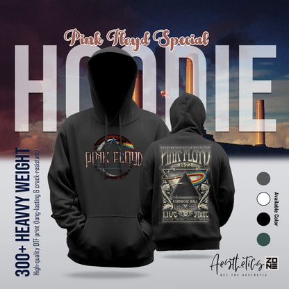 Black hoodie with Pink Floyd design on front and back, set against a scenic background.