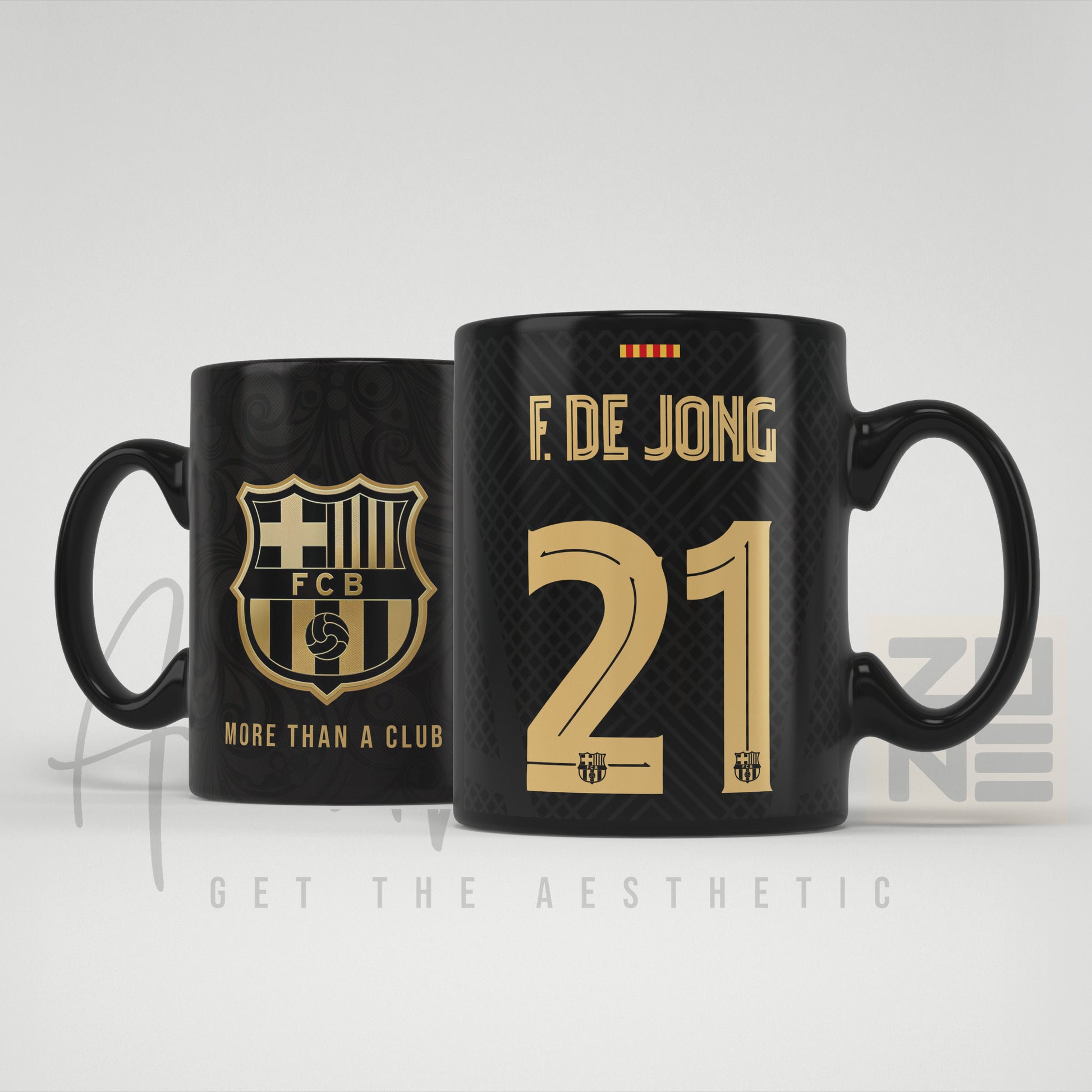 Two black mugs with gold text and branding on a light gray background
