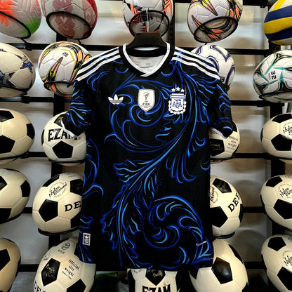 Blue sports jersey with white stripes surrounded by various soccer balls on a black background