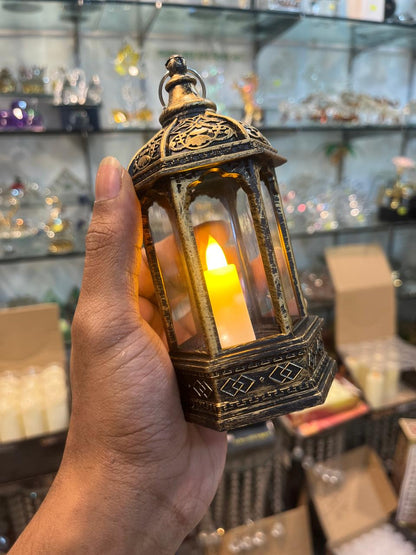 Decorative lantern held by a hand with a blurred store background