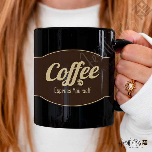 Black mug with 'Coffee Espress Yourself' text held by a person with red hair.