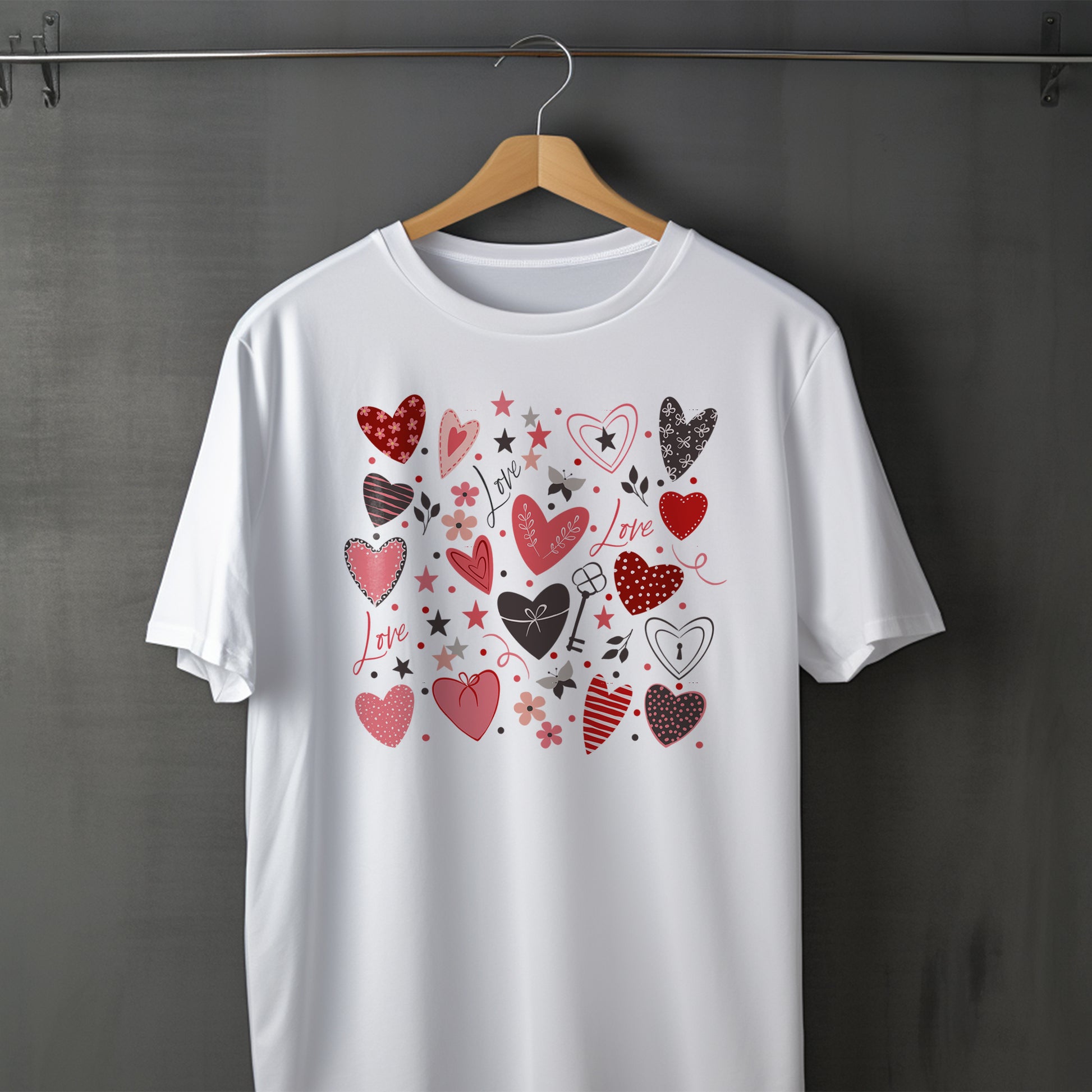 White t-shirt with heart designs on a hanger against a gray background